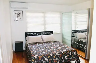 a bedroom with a bed and a mirror at Los Angeles Blue Nest in Monterey Park