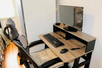 a desk with a computer monitor and a keyboard and mouse at Los Angeles Blue Nest in Monterey Park
