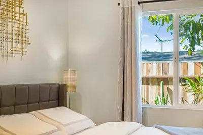 a bedroom with a bed and a window at Remodeled House Near Disneyland in Fullerton