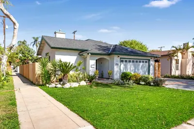 a house with a yard with green grass at Remodeled House Near Disneyland in Fullerton