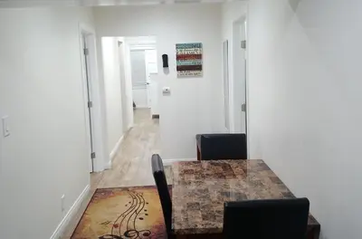 a room with a table and chairs and a hallway at Vacation Unit is Available for Business and Family Trip in Long Beach