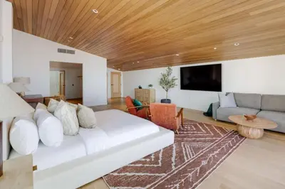a living room with a white couch and a wooden ceiling at The Santa Monica Sunset - 5k sq ft beachfront luxury in Los Angeles