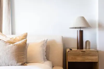 a lamp on a night stand next to a bed at The Santa Monica Sunset - 5k sq ft beachfront luxury in Los Angeles