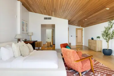 a living room with a white couch and a wooden ceiling at The Santa Monica Sunset - 5k sq ft beachfront luxury in Los Angeles