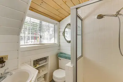 a bathroom with a toilet and a sink and a shower at Walkable Green Gables Cottage in Lake Arrowhead in Lake Arrowhead
