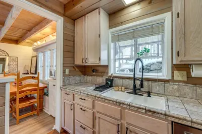 a kitchen with a sink and a window at Walkable Green Gables Cottage in Lake Arrowhead in Lake Arrowhead