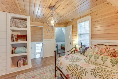 a bedroom with a bed and a wooden ceiling at Walkable Green Gables Cottage in Lake Arrowhead in Lake Arrowhead
