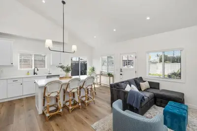 a kitchen and living room with a couch and a table at Coastal Modern 3 Bed 2 Bath, Pet Friendly in Hawthorne