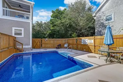 a swimming pool in a backyard with a wooden fence at Particle Ocean View 2505B W 5th St in Los Angeles
