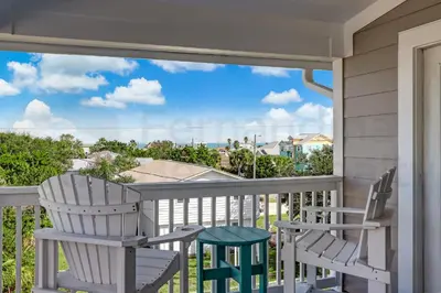 two chairs on a porch with a view of the ocean at Particle Ocean View 2505B W 5th St in Los Angeles