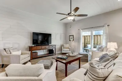 a living room with white furniture and a flat screen tv at Particle Ocean View 2505B W 5th St in Los Angeles