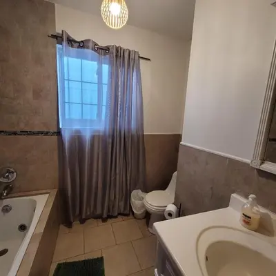 a bathroom with a sink and a toilet and a shower at 3 bedroom 2 bath home with Jacuzzi near Beverly Hills, wi-fi, Jacuzzi, Roku, BBQ, giant games family fun in Los Angeles