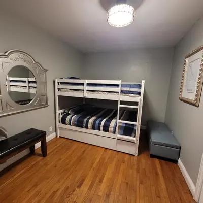 a bedroom with a bunk bed with a mirror at 3 bedroom 2 bath home with Jacuzzi near Beverly Hills, wi-fi, Jacuzzi, Roku, BBQ, giant games family fun in Los Angeles