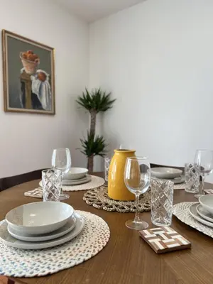a dining room table with plates and wine glasses at Seaside Escape Steps from Santa Monica Beach in Los Angeles