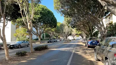 a street with cars parked on the side of the road at Seaside Escape Steps from Santa Monica Beach in Los Angeles