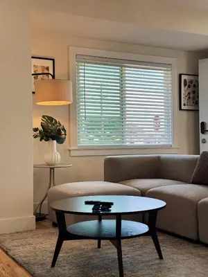 a living room with a couch and a table at Cozy Private Room A in S Central LA in Los Angeles