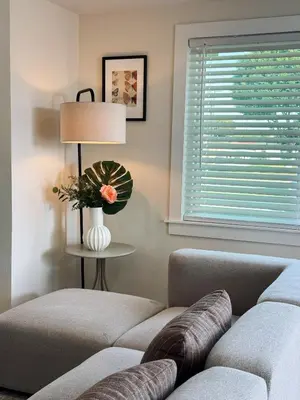 a living room with a couch and a lamp and a window at Cozy Private Room A in S Central LA in Los Angeles