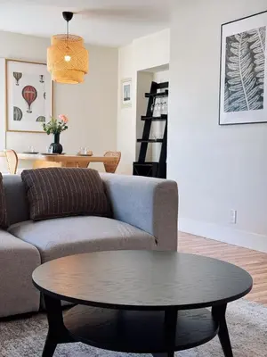 a living room with a couch and a table at Cozy private room B in S Central LA in Los Angeles