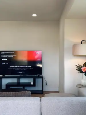 a living room with a large flat screen tv on a wall at Cozy private room B in S Central LA in Los Angeles