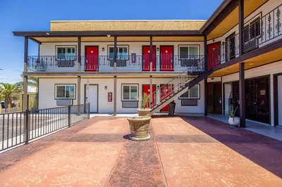 a building with a staircase in front of it at Hotel Avenida Victorville I 15 in Victorville