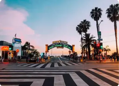 an empty street with a crosswalk in a city with palm trees at Spacious Single Apt D In Santa Monica in Los Angeles