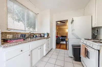 a kitchen with white cabinets and a white refrigerator at Spacious Single Apt D In Santa Monica in Los Angeles