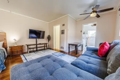 a living room with a couch and a tv at Spacious Single Apt D In Santa Monica in Los Angeles
