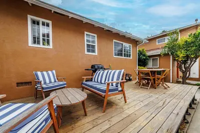 a wooden deck with two chairs and a grill at Spacious Single Apt D In Santa Monica in Los Angeles