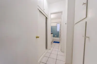 a hallway with a bathroom with a toilet and a window at Spacious Single Apt D In Santa Monica in Los Angeles