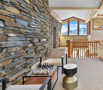 a living room with a stone wall with a chessboard at A California Country Experience - Tehachapi in Tehachapi