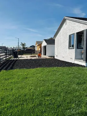 a white house with a yard and a fence at Cozy private Room D in S Central LA in Los Angeles