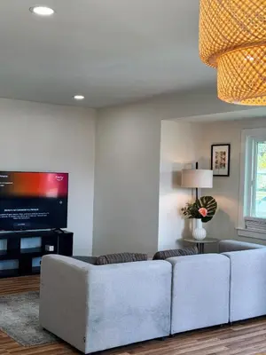 a living room with a couch and a flat screen tv at Cozy private Room D in S Central LA in Los Angeles