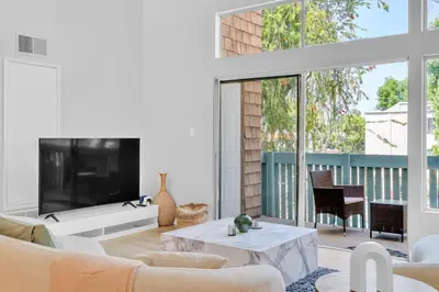 a living room with a large tv and a couch at High Ceilings 3BR with Loft-2 Baths Pool & Jacuzzi in Tarzana