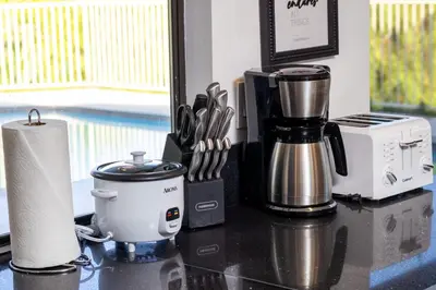 a counter with a coffeemaker and a coffee maker at Off Grid Mountaintop Paradise Pool Spa and Games in San Bernardino