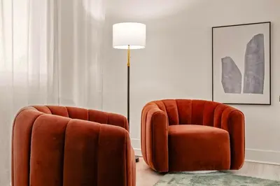 two orange chairs and a lamp in a room at 5BR Fun Haven Pool Mini Golf Movie Game room in Riverside