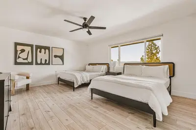 a bedroom with two beds and a ceiling fan at 5BR Fun Haven Pool Mini Golf Movie Game room in Riverside