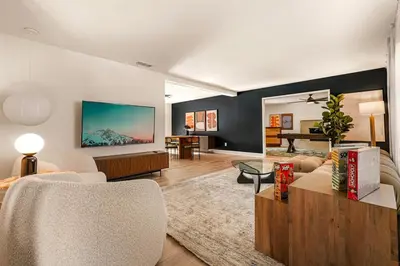 a living room with a couch and a table at 5BR Fun Haven Pool Mini Golf Movie Game room in Riverside