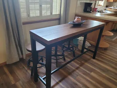 a wooden table in a kitchen with a counter at Extremely Chill 3 Bedroom Home in Long Beach