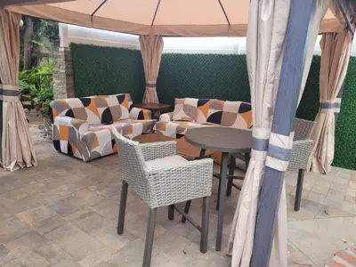 a patio with a table and chairs and an umbrella at Extremely Chill 3 Bedroom Home in Long Beach