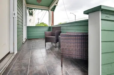 a porch with chairs and tables on a house at Home 1 Mi to DTLA Room to Work and Relax! in Los Angeles