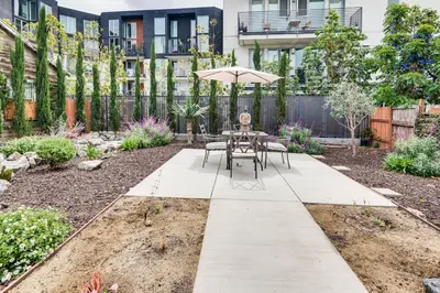 a patio with a table and chairs and an umbrella at Home 1 Mi to DTLA Room to Work and Relax! in Los Angeles