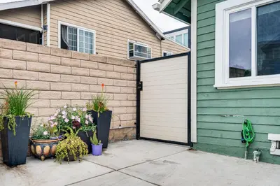 a garage door on a house with flowers and plants at Home 1 Mi to DTLA Room to Work and Relax! in Los Angeles