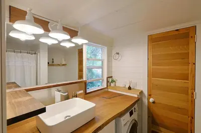 a bathroom with a white sink and a mirror at Topanga Canyon Oasis by Colby & Conrad in Topanga