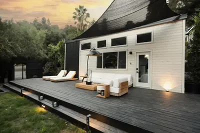 a house with a deck with a couch and chairs at Topanga Canyon Oasis by Colby & Conrad in Topanga