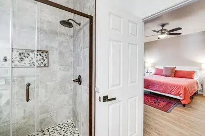 a bedroom with a bed and a shower at Swim, Hike, Ski and Unwind Lake Arrowhead Retreat! in Lake Arrowhead
