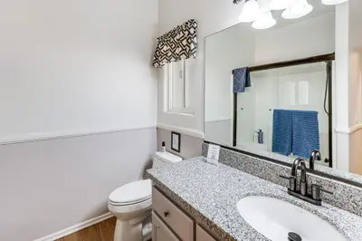 a bathroom with a sink and a toilet and a mirror at Swim, Hike, Ski and Unwind Lake Arrowhead Retreat! in Lake Arrowhead