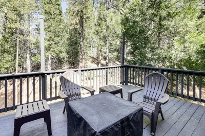 two chairs and a table on a deck at Swim, Hike, Ski and Unwind Lake Arrowhead Retreat! in Lake Arrowhead