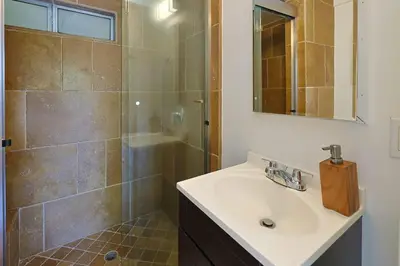 a bathroom with a sink and a shower at The Topanga Bungalow by Colby & Conrad in Topanga