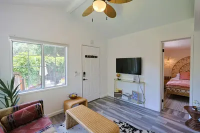 a living room with a couch and a flat screen tv at The Topanga Bungalow by Colby & Conrad in Topanga