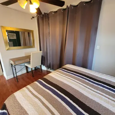 a bedroom with a bed and a desk at LA Getaway Oasis in Los Angeles
